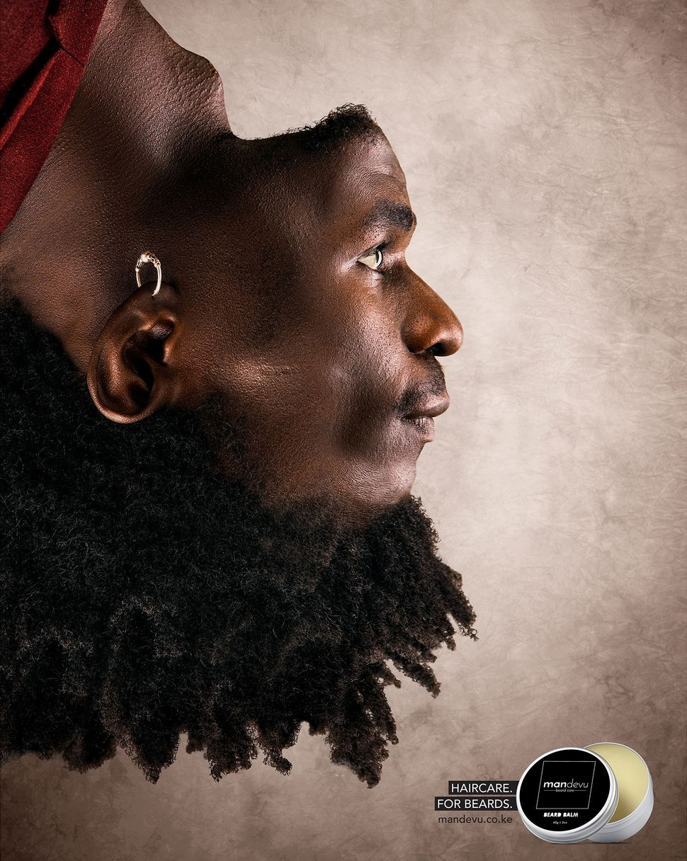 A magazine ad for beard care products showing a man's head upside down but its face edited in the regular position, causing his hair to appear as his beard.